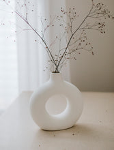 Load image into Gallery viewer, Soft white ceramic vase donut shape with dried flower and white background
